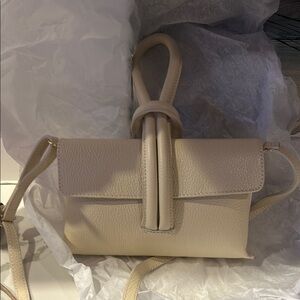 Cream purse with cross body strap
